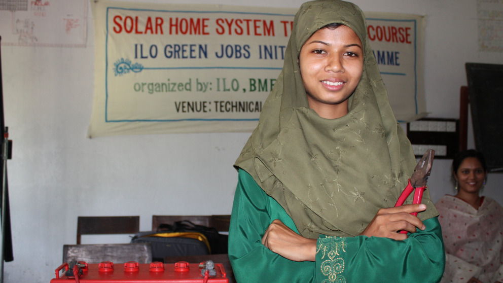 A trainee in Bangladesh learns how to maintain solar panels. Her training was organised by the International Labour Organisation (ILO), a specialised agency of the United Nations.